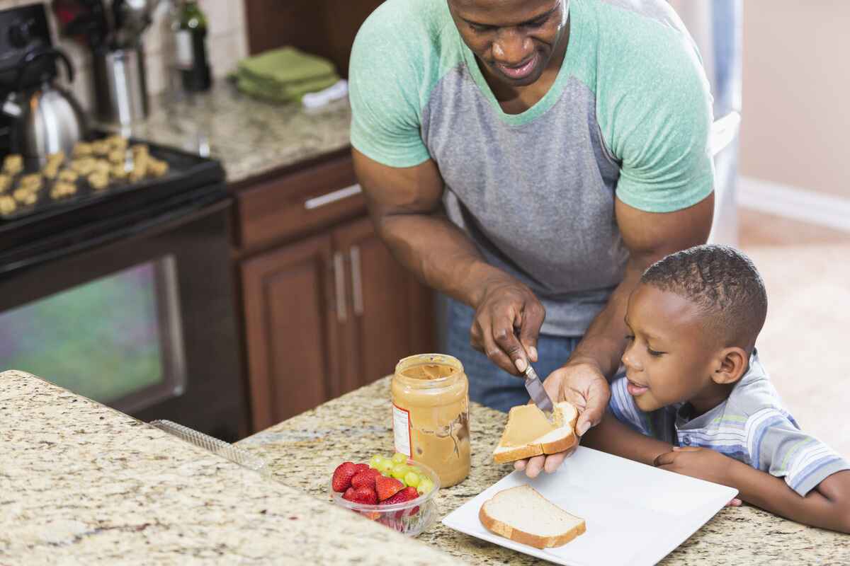 Little boy treated for peanut allergies waits for a peanut butter sandwich.