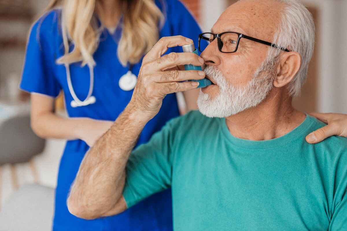 Man with asthma uses an inhaler