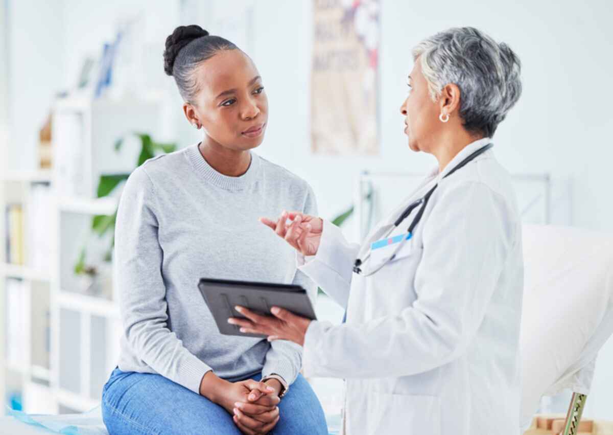 Patient preparing for an endoscopy talks to her doctor