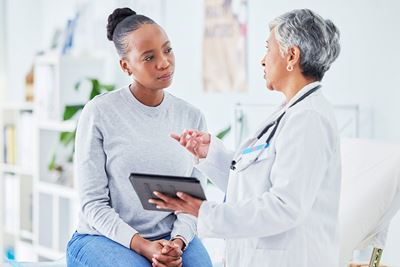A young adult patient talking with a doctor