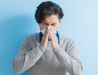 man sneezing