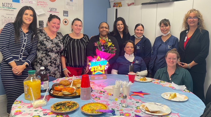 Lena Rodriguez, medical assistant (center, with flowers)